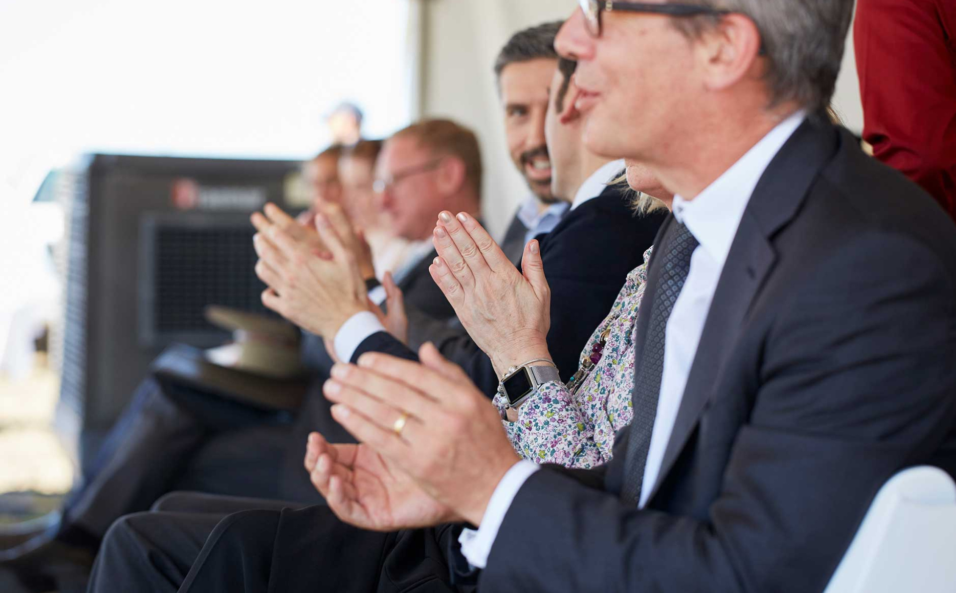 People clapping in a meeting